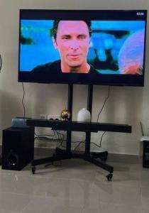 AED 140, Rolling Tv Stand; Can Hold Up To 65 Inch Tv